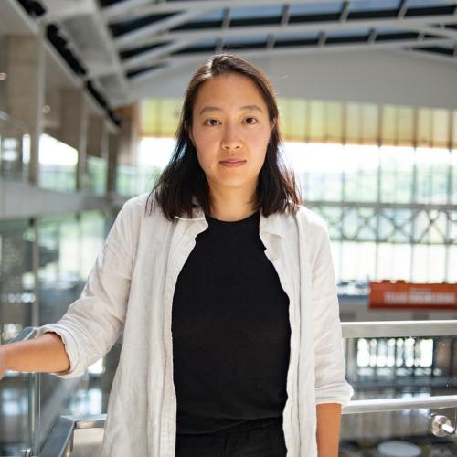Woman with hand on banister.