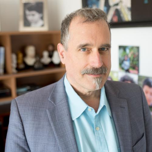 Man with mustache in blazer.