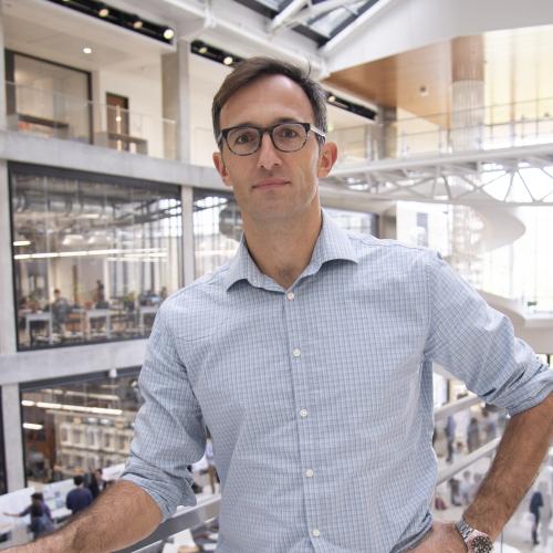 Man with hand on banister.